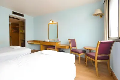 a bedroom with a table and chairs and a mirror at XX Wish Inn BTS Chidlom - วิช อินน์ บีทีเอส ชิดลม in Pratunam