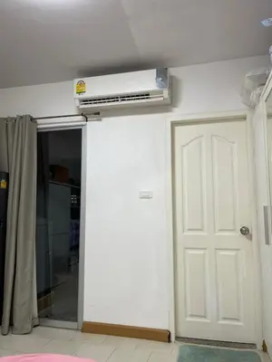 a room with a white door and a air conditioner on the ceiling at Love Nest in Bangkok