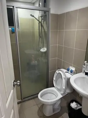 a bathroom with a shower and a toilet and a sink at Love Nest in Bangkok