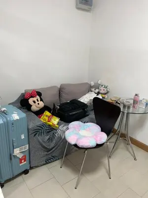 a living room with a couch with stuffed animals and a table at Love Nest in Bangkok