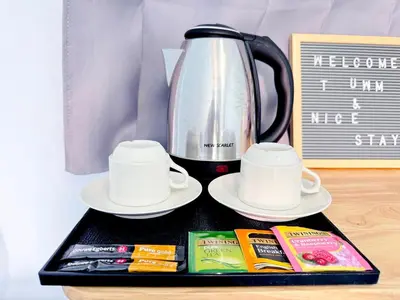 a tray with a tea pot and cups and books at Titi-pon Apartment Bang Khen in Bang Khen