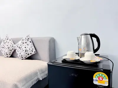 a coffee maker on a table next to a bed at Titi-pon Apartment Bang Khen in Bang Khen