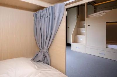 a bedroom with a bed with a curtain at DMK Place in Bangkok
