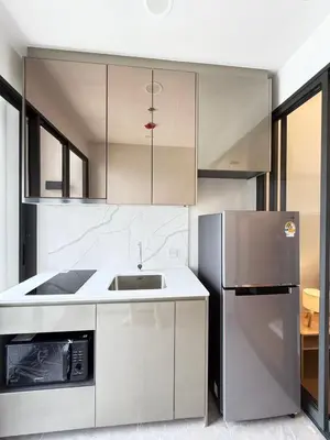 a kitchen with a refrigerator and a sink at Brand New Condo in Bangkok