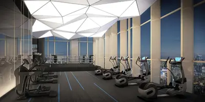 a gym with treadmills and ellipticals in a building at Brand New Condo in Bangkok