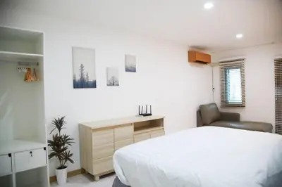 a bedroom with a bed and a desk and a chair at Near BTS Bearing Skytrain- Homey living Townhome - 4 Bedrooms in Bangkok