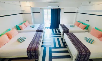 three beds in a room with blue and white at The Locals Bangkok Old Town in Bangkok