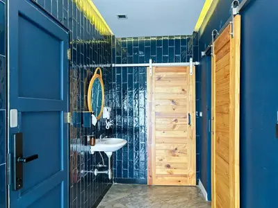 a bathroom with a sink and a blue wall at The Locals Bangkok Old Town in Bangkok