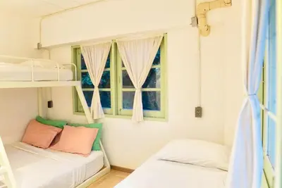 two bunk beds in a room with a window at The Green Khaosan Bangkok in Bangkok
