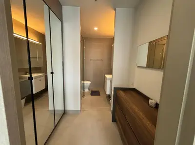 a bathroom with a toilet and a sink and a mirror at King Bed Studio in Bangkok