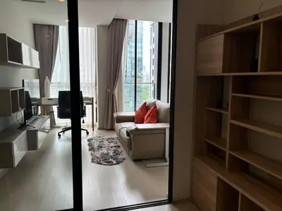 a living room with a couch and a desk at King Bed Studio in Bangkok
