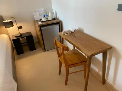 a wooden table and a chair in a room at The Celestrail - Apartment - Check-In by Appointment Only - Non-hotel - Onnut BTS in Amphoe Phra Khanong