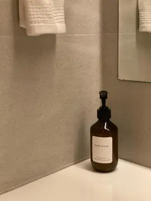 a bottle of soap sitting on a counter in a bathroom at The Celestrail - Apartment - Check-In by Appointment Only - Non-hotel - Onnut BTS in Amphoe Phra Khanong