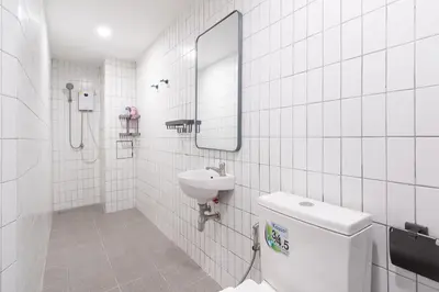 a bathroom with a sink and a mirror and a toilet at Wash House Chatuchak in Bangkok