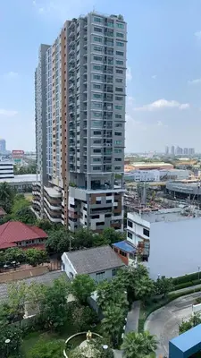 a large tall building in a city with buildings at Tranquil Urban Retreat at Cheangwattana in Pak Kret