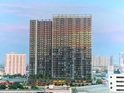 a large tall building in the middle of a city at Tranquil Urban Retreat at Cheangwattana in Pak Kret
