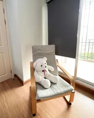 a teddy bear sitting on a chair in a room at Tranquil Urban Retreat at Cheangwattana in Pak Kret