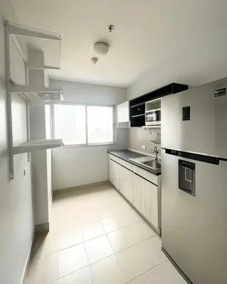 a white kitchen with a sink and a refrigerator at Tranquil Urban Retreat at Cheangwattana in Pak Kret