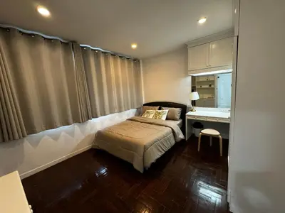 a small bedroom with a bed and a desk at Comfy Crib Hostel 2 in Bangkok