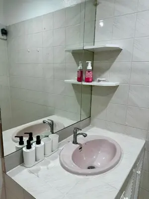 a bathroom with a sink and a mirror at Comfy Crib Hostel 2 in Bangkok