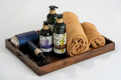 a wooden tray with wine bottles and towels at Story At Bangkok- 211 Studio with Balcony in Khlong Toei