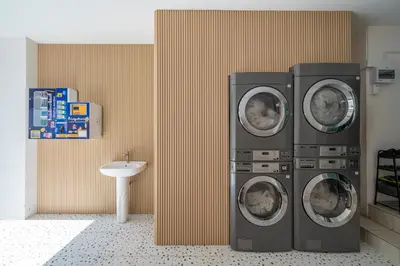 two washing machines in a bathroom with a sink at Story At Bangkok- 211 Studio with Balcony in Khlong Toei