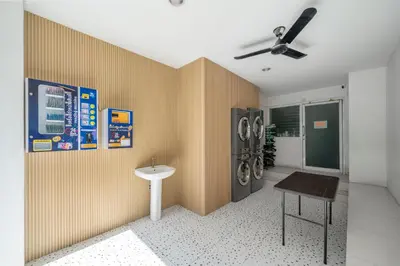 a laundry room with a washer and dryer at Story At Bangkok- 211 Studio with Balcony in Khlong Toei