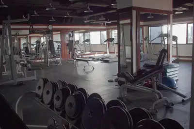 a gym with a bunch of machines in it at Spacious room in Sukhumvit Nana in Bangkok