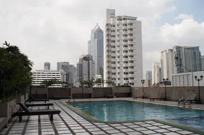 a swimming pool on top of a building with a city skyline at Spacious room in Sukhumvit Nana in Bangkok
