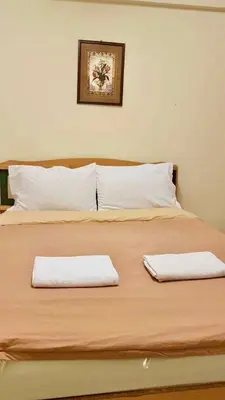 a bedroom with a bed with two towels on it at Nakara Place บ้าน นาครา in Ban Rang Pho