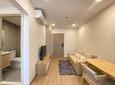 a living room with a couch and a table at Modern room with Pool and Gym in the city center just 600m from Subway station! in Bangkok