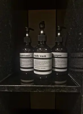 a group of three bottles sitting on a shelf at Modern room with Pool and Gym in the city center just 600m from Subway station! in Bangkok
