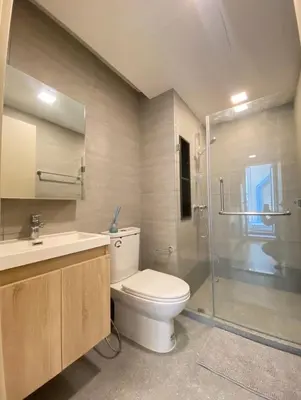 a bathroom with a toilet and a glass shower at Modern room with Pool and Gym in the city center just 600m from Subway station! in Bangkok