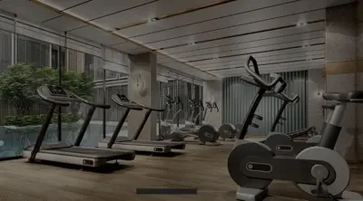 a gym with several cardio machines in a room at Modern room with Pool and Gym in the city center just 600m from Subway station! in Bangkok