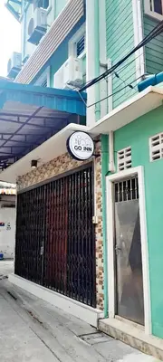 a blue building with a gate and a sign on it at xx GO INN The Giant Swing โก อินน์ เสาชิงช้า in Bangkok