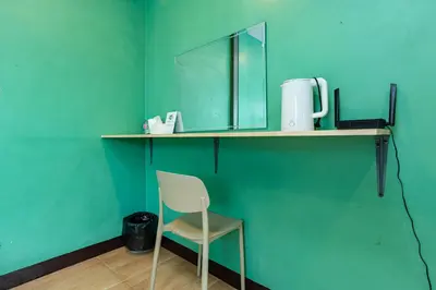 a chair sitting on a shelf with a mirror at xx GO INN The Giant Swing โก อินน์ เสาชิงช้า in Bangkok