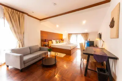 a living room with a couch and a bed at Mak Sukhumvit 15 in Bangkok
