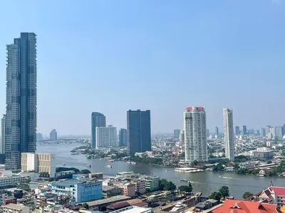 a view of a city with a river and buildings at Opulence Riverview with Train Access in Bangkok