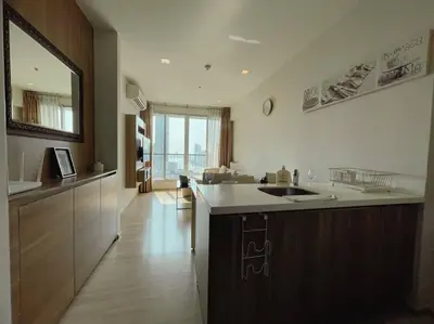 a kitchen with a sink and a counter top at Opulence Riverview with Train Access in Bangkok