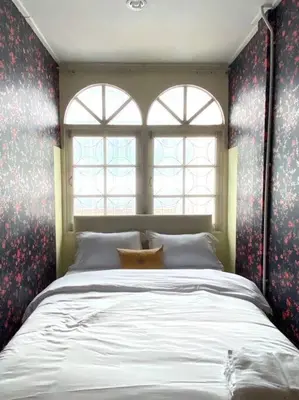 a bedroom with a large bed with red floral wallpaper at Entire House 6 people 3Beds 2Baths near BTS Asoke Terminal21 in Bangkok