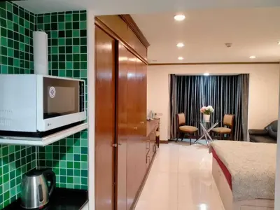 a hotel room with green tile on the walls at Spacious 1,2 & 3 Bedroom Serviced Apartments OMNI - Nana BTS in Bangkok
