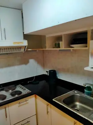 a kitchen with a sink and a counter top at Spacious 1,2 & 3 Bedroom Serviced Apartments OMNI - Nana BTS in Bangkok