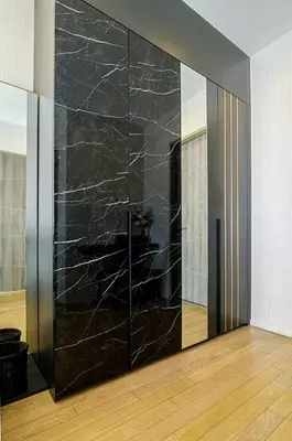 a black wall with a mirror in a room at Cosy apartment - BTS Phrom phong in Bangkok