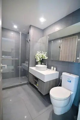 a bathroom with a toilet and a sink and a shower at Cosy apartment - BTS Phrom phong in Bangkok