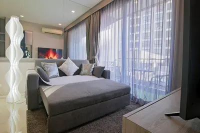 a bedroom with a bed and a large window at Cosy apartment - BTS Phrom phong in Bangkok