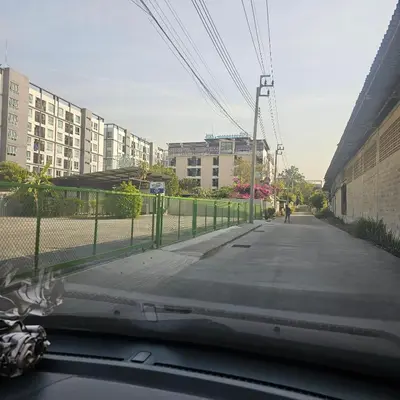 a view from a car window of a street with buildings at bang khun thian14 in Sathani Wat Sing