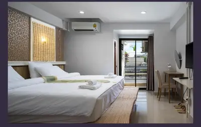 a bedroom with a bed and a desk and a television at bang khun thian14 in Sathani Wat Sing