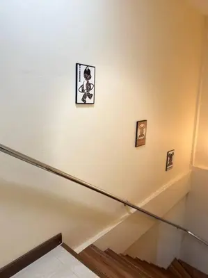a staircase with three pictures on the wall in a building at 10MIN \u66fc\u8c37\u72ec\u680bChatuchack,Kasetsart\u7cbe\u54c1\u522b\u5885 MYSTORY HOUSE in Bangkok