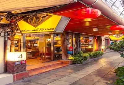 a restaurant with a sign on the front of it at Collection O Diamond House Khaosan in Bangkok