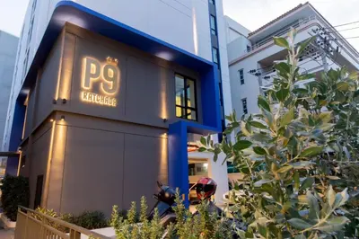 a building with a sign that reads pp collective at P9 Ratchada Hotel in Bangkok